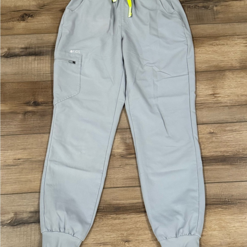 Figs Technical Collection Gray women’s Jogger Pants with Neon Yellow drawstring.